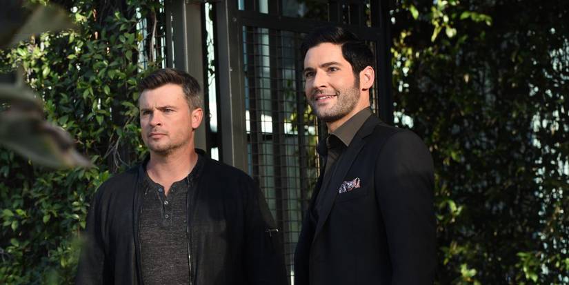 Tom Welling and Tom Ellis looking ahead while outdoors in Lucifer.