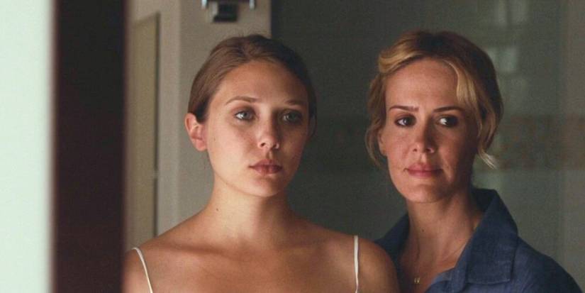 Martha and Lucy look into a bathroom mirror in Martha Marcy May Marlene