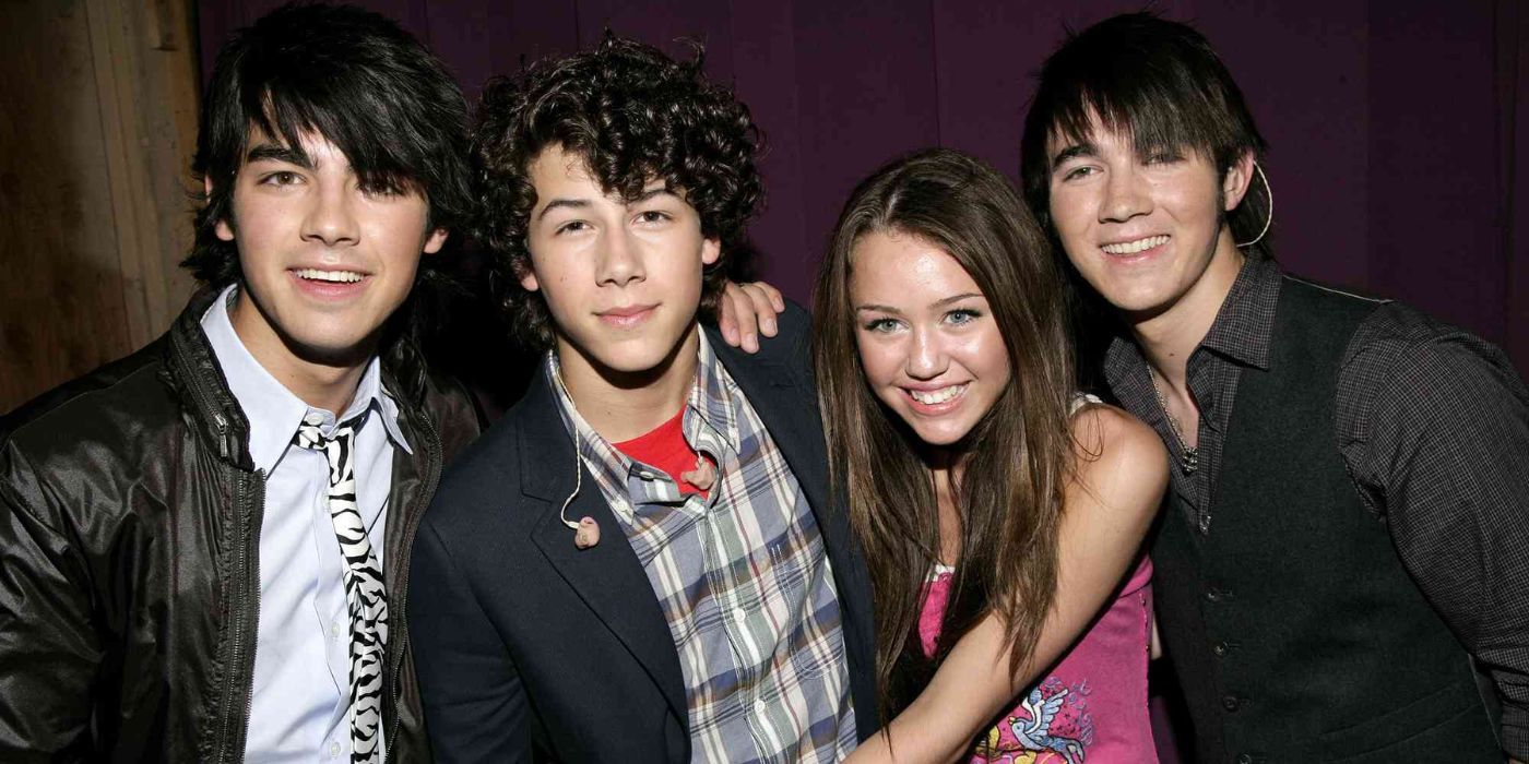 Joe Jonas, Nick Jonas, Miley Cyrus, and Kevin Jonas together.