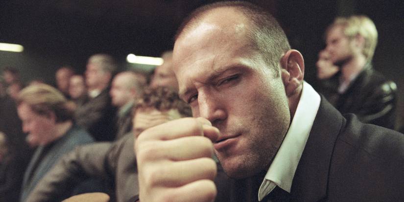 Jason Statham as Turkish in Snatch giving a fist bump while looking at the camera.