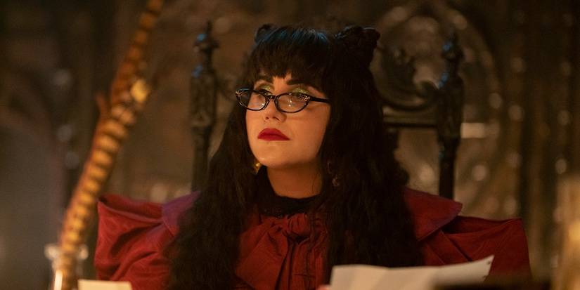 Natasia Demetriou as Nadja peeking over her glasses in the What We Do in the Shadows episode "Private School"