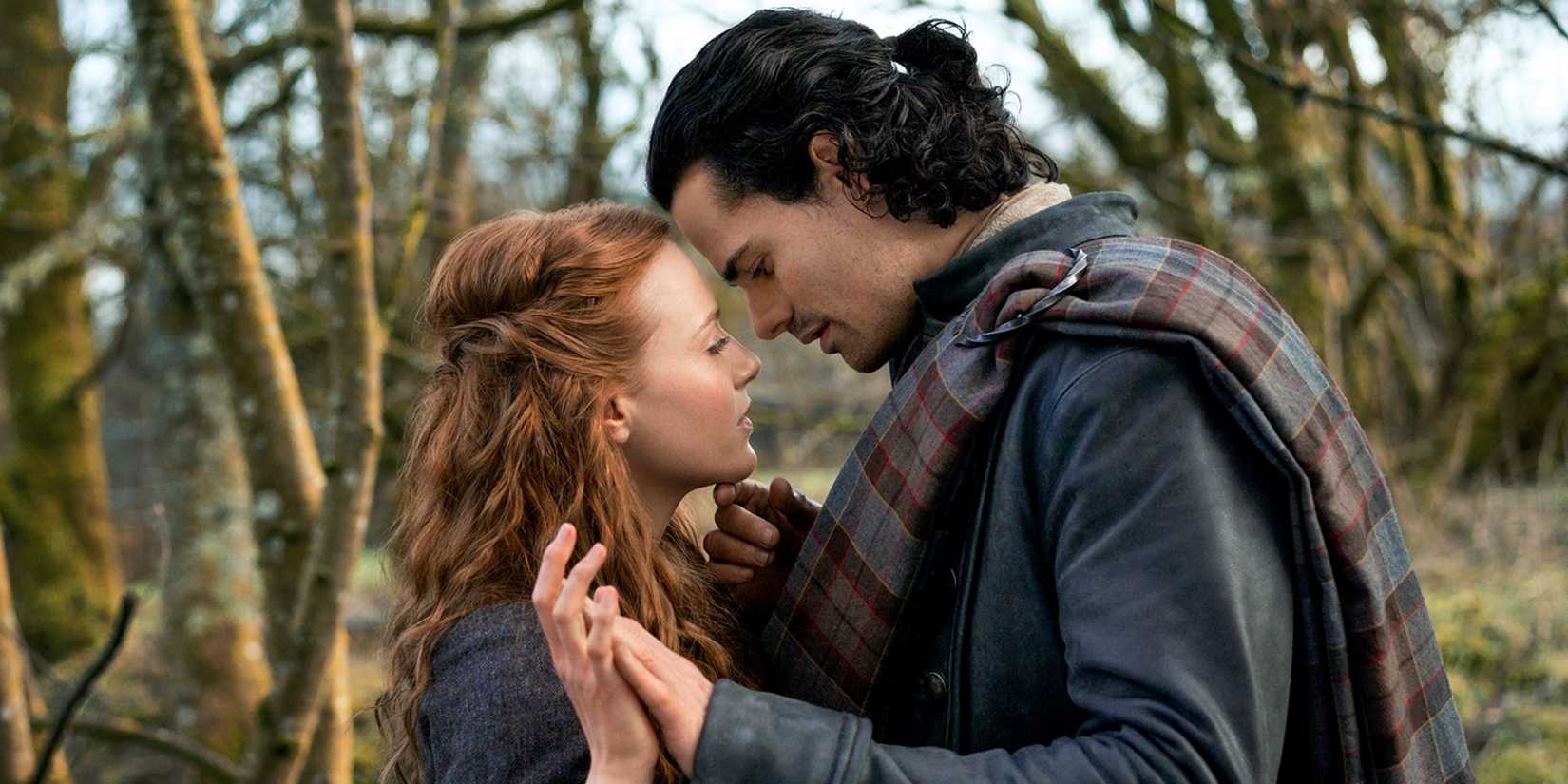 Harriet Slater as Ellen and Jamie Roy as Brian touching foreheads and hands in Outlander: Blood of My Blood