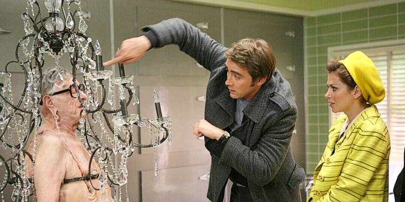 Ned the Piemaker and Chuck Charles investigating a dead body in a chandelier in 'Pushing Daisies' Season 2.