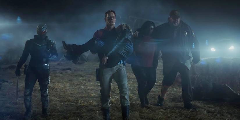 Vigilante (Freddie Stroma), Peacemaker (John Cena), Harcourt (Jennifer Holland), Abedayo (Danielle Brooks), and Economos (Steve Agee) walking away in Peacemaker