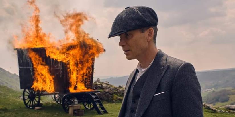 Cillian Murphy as Tommy in the English countryside with a burning caravan in Peaky Blinders Season 6.