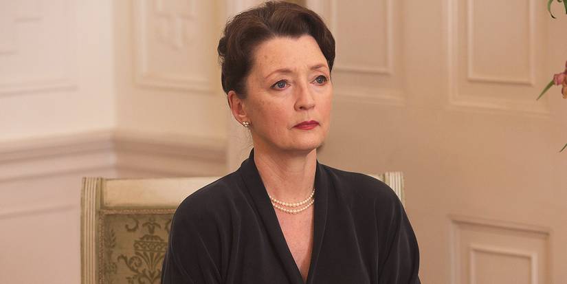 A woman sitting sternly in a fancy chair in Phantom Thread