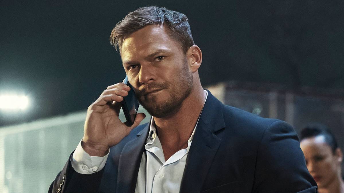 Alan Ritchson on the phone in 'Reacher.'
