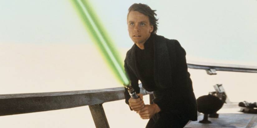 Mark Hamill as Luke Skywalker, posing with a green lightsaber in Return of the Jedi - 1983