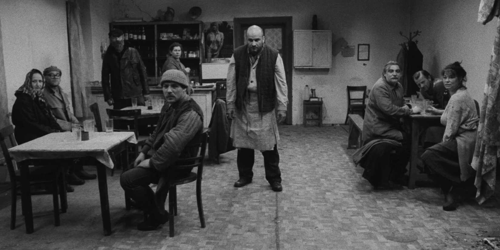 Several villagers in a bar in Satantango 