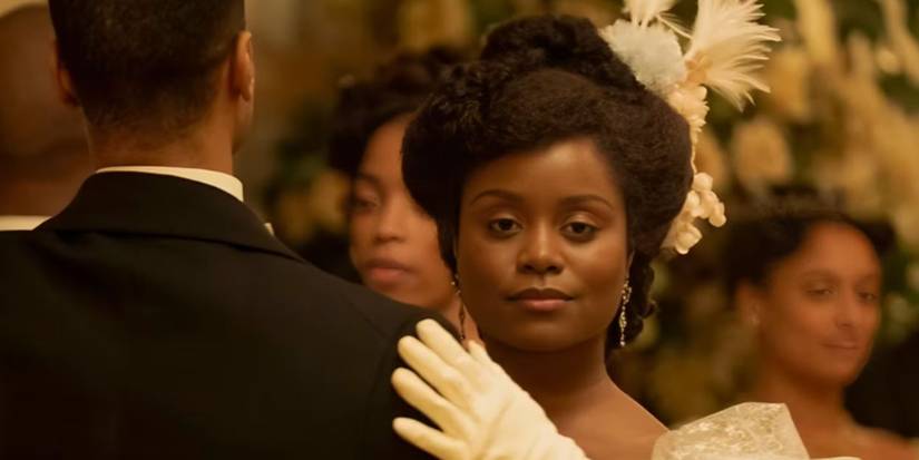 Denee Benton as Peggy Scott wearing white gloves and dancing at a ball in 'The Gilded Age'
