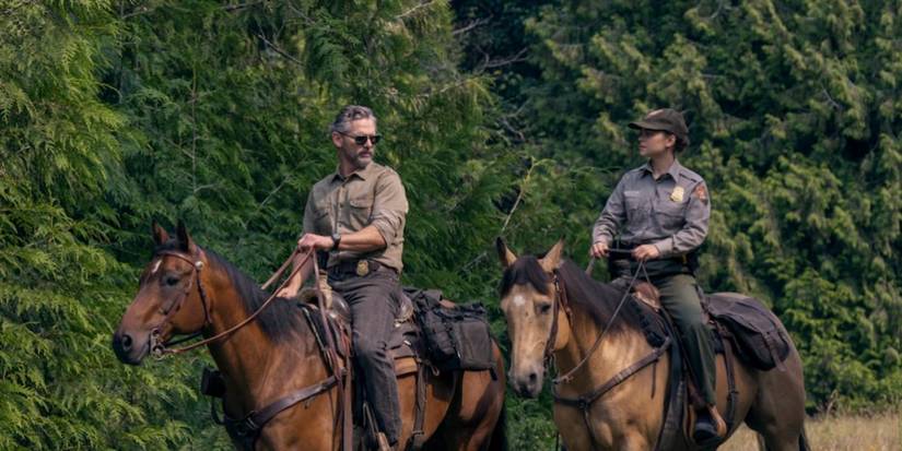 Eric Bana and Lily Santiago as Kyle and Naya on horseback in a field in 'Untamed'.