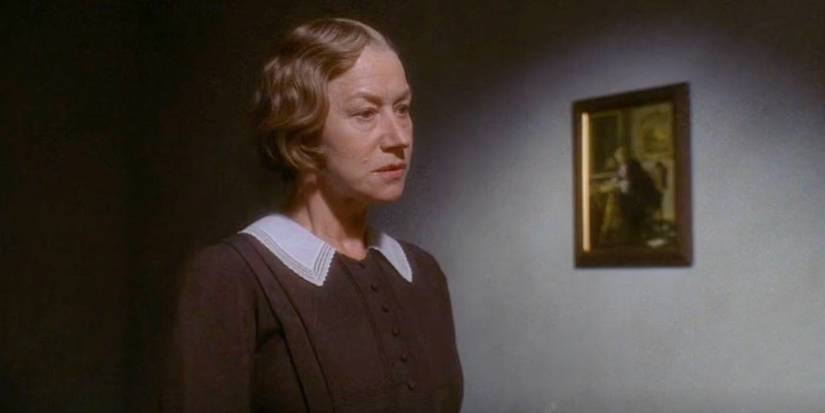 Helen Mirren stands in a room in Gosford Park.
