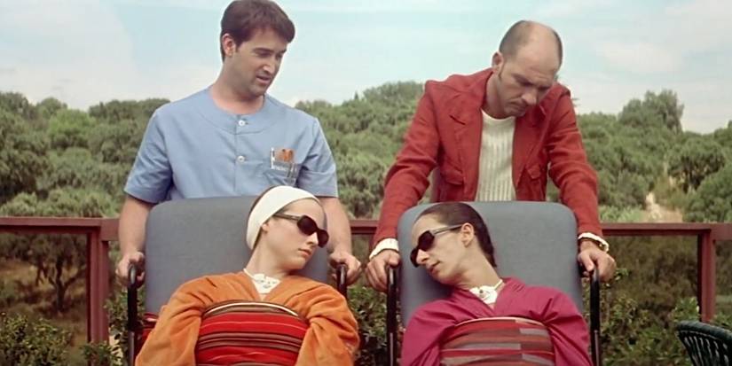 Benigno (Javier Cámara) and Marco (Darío Grandinetti) stand over two women in comas in the 2002 film Talk to Her.