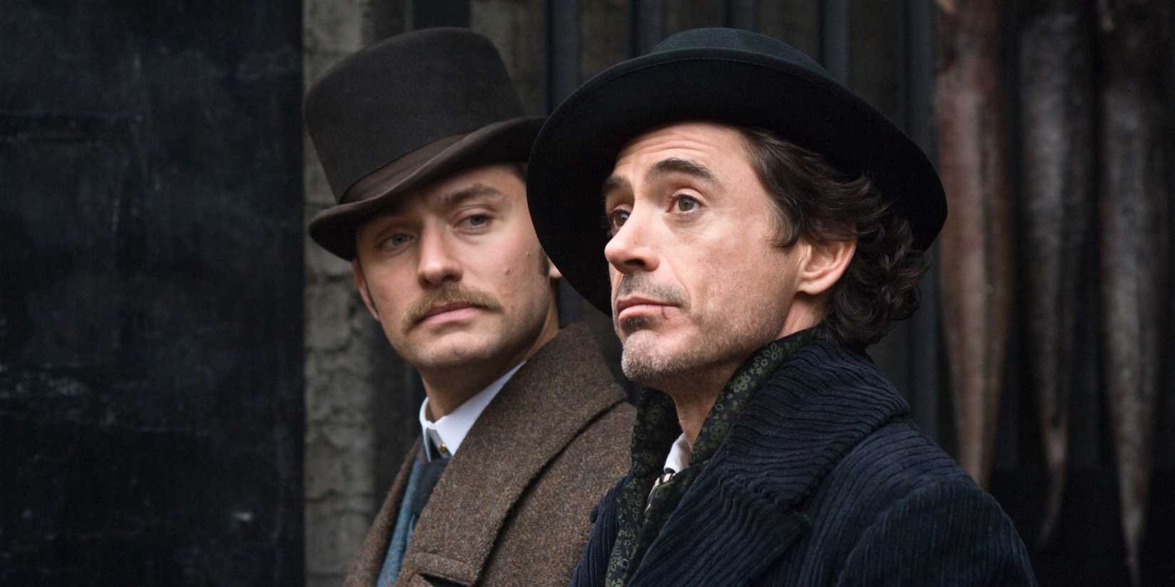 Robert Downey Jr. and Jude Law chat on the street as Sherlock and Watson in 2009's Sherlock Holmes by Guy Ritchie.