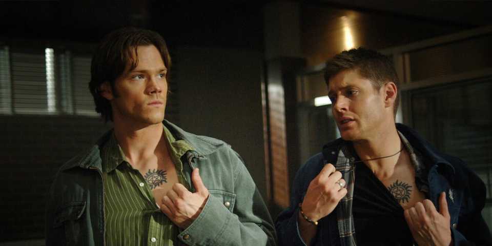 Sam Winchester (Jared Padalecki) and Dean Winchester (Jensen Ackles) reveals their tattoos in the 'Supernatural' episode "Jus in Bello"