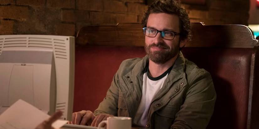 Chuck Shurley (Rob Benedict) at his computer in 'Supernatural' Season 11.