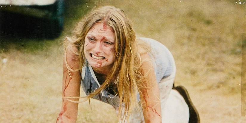 A woman crying and crawling on the ground in Texas Chain Saw Massacre