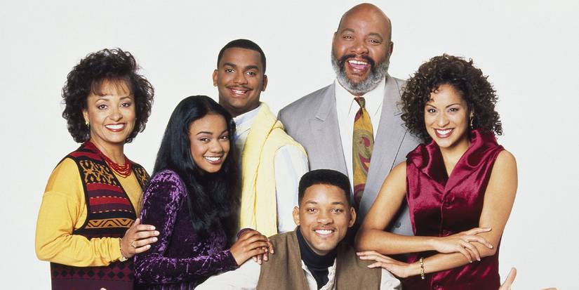 The Fresh Prince of Bel-Air cast smile at the camera with a plain background.