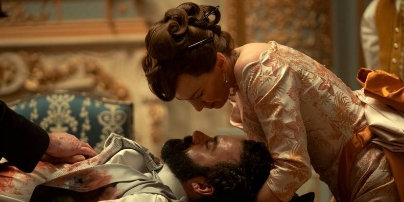 Carrie Coon as Bertha bent over Morgan Spector as George hoping he survives a bullet wound in The Gilded Age.