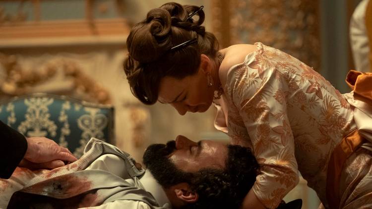 Carrie Coon as Bertha bent over Morgan Spector as George hoping he survives a bullet wound in The Gilded Age.