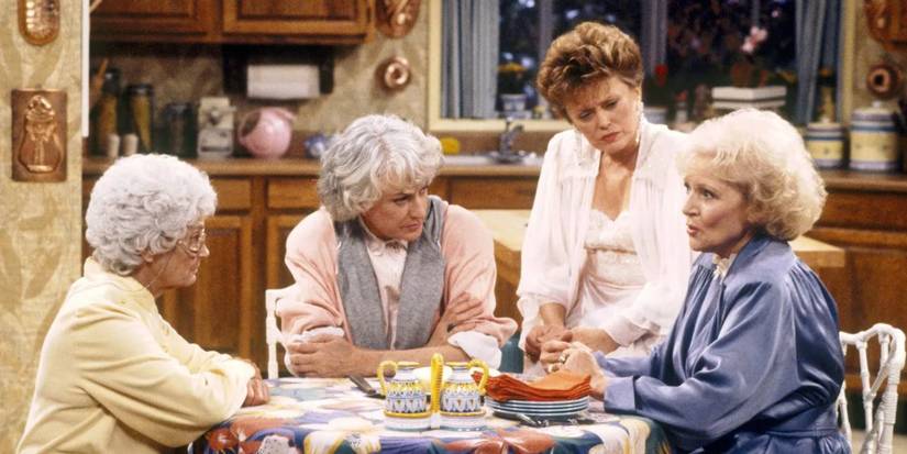 Estelle Getty, Beatrice Arthur, Rue McClanahan, and Betty White sitting around a table in 'The Golden Girls'