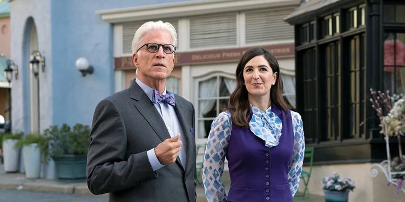 Ted Danson as Michael and D'Arcy Carden walk through a picturesque city on The Good Place.
