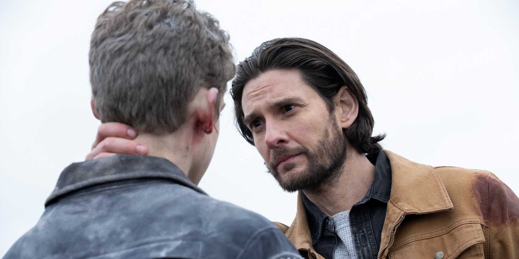 Ben Barnes as Tim bent over to look Joe Freeman as Luke in the eyes in The Institute