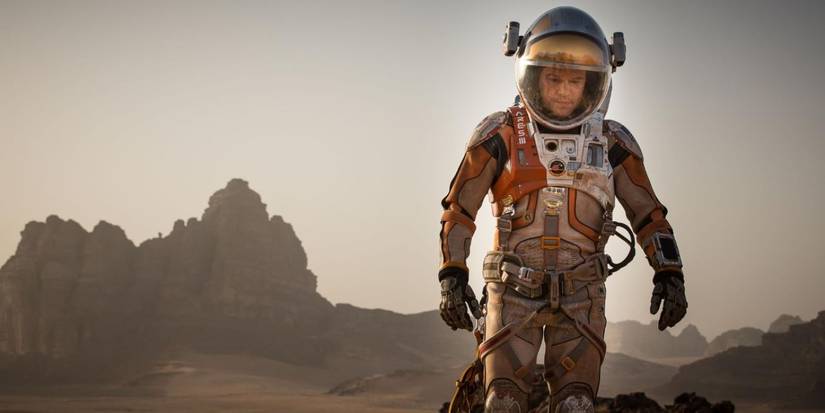 Matt Damon walking alone in Mars weating a space suit in The Martian