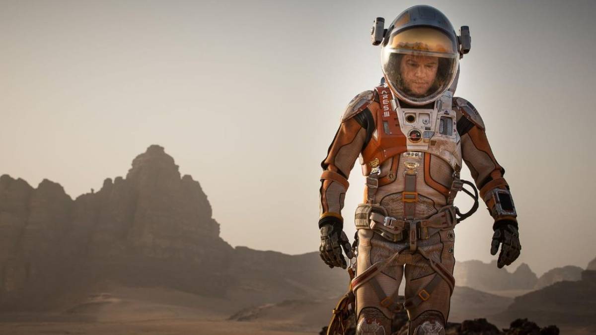 Matt Damon walking alone in Mars weating a space suit in The Martian