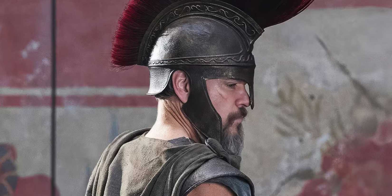 Matt Damon wearing a helmet and looking in profile as Odysseus in The Odyssey.