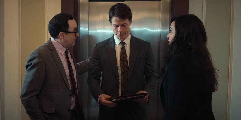 P.J. Byrne, Milo Callaghan, and Lana Parrilla talk near an elevator in The Rainmaker