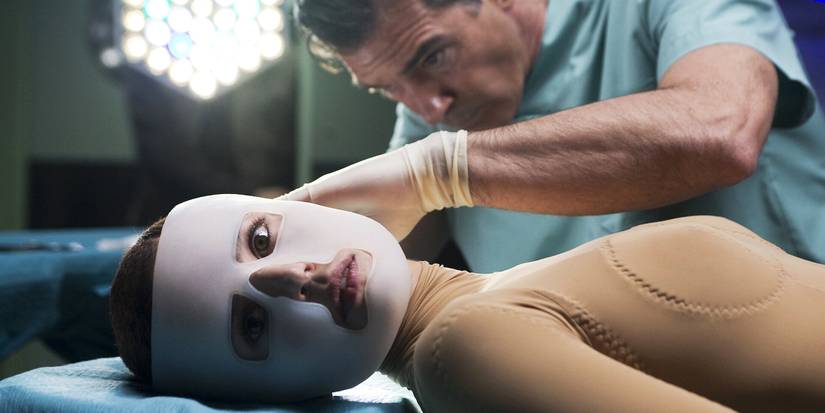 Antonio Banderas operating on a woman, who's looking at the camera, in The Skin I Live In