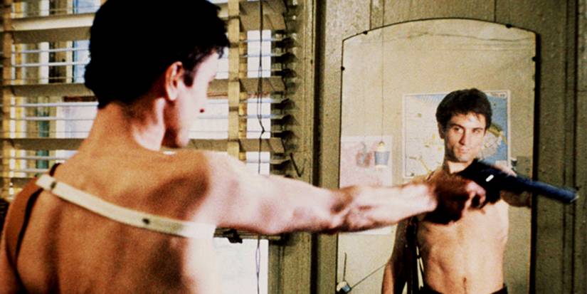 Travis Bickle looking in the mirror and holding a gun in Taxi Driver.