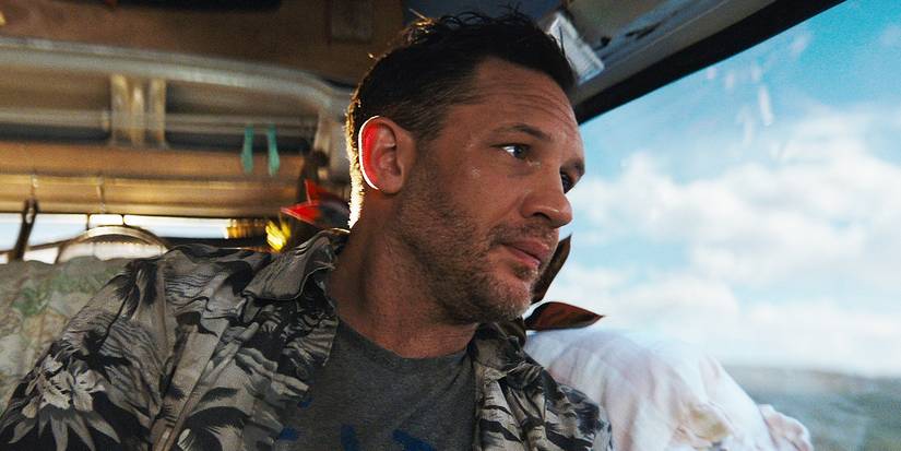 Tom Hardy sitting in a window seat in Venom The Last Dance