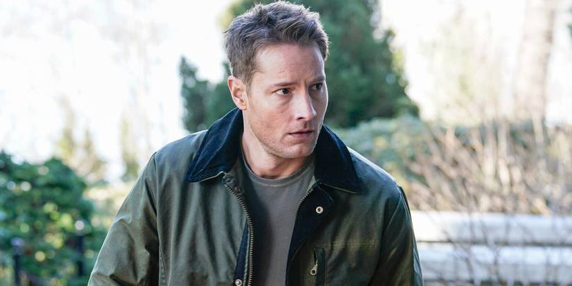 Justin Hartley as Colter Shaw looking at something to the side while standing outdoors in Tracker Season 3.