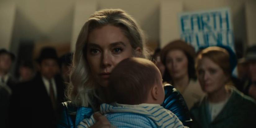 Sue holds her baby Franklin in front of an angry crowd in The Fantastic Four: First Steps.