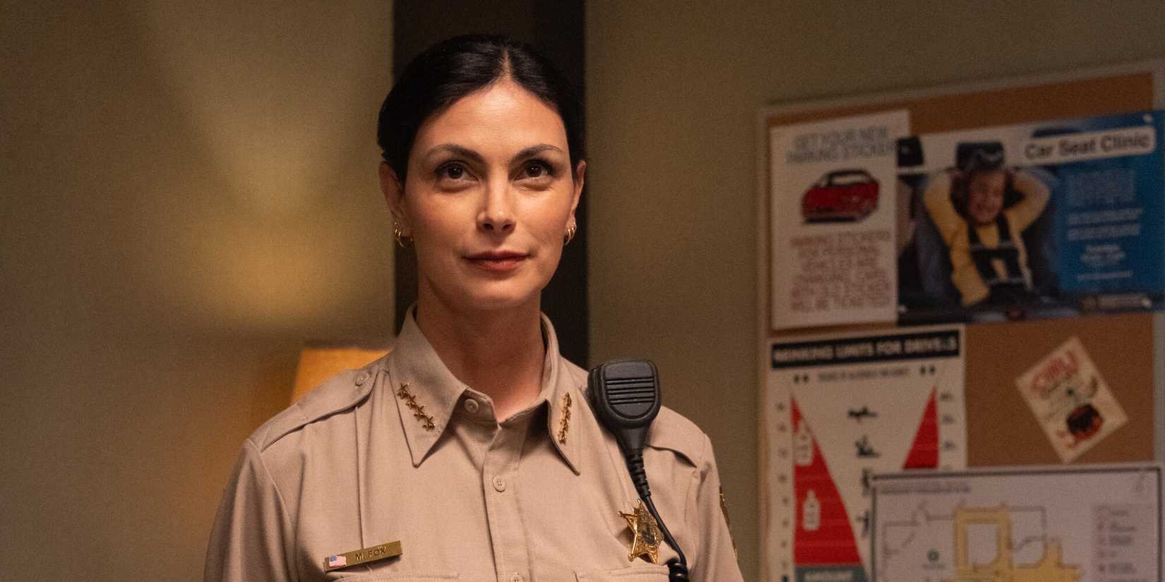 Morena Baccarin as Mickey Fox at the police station in her uniform in Sheriff Country