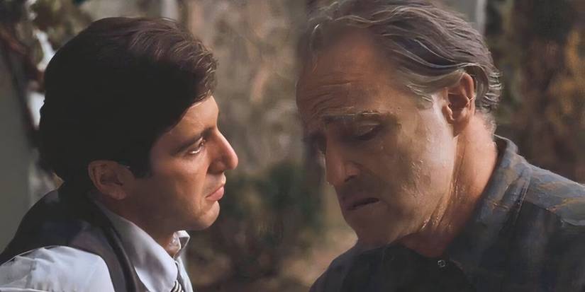 Al Pacino sitting next to Marlon Brando in The Godfather (1972)