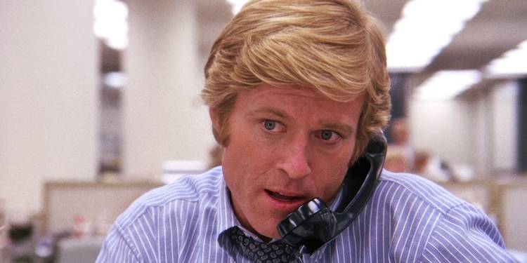 Robert Redford on the phone in an office in All the President's Men
