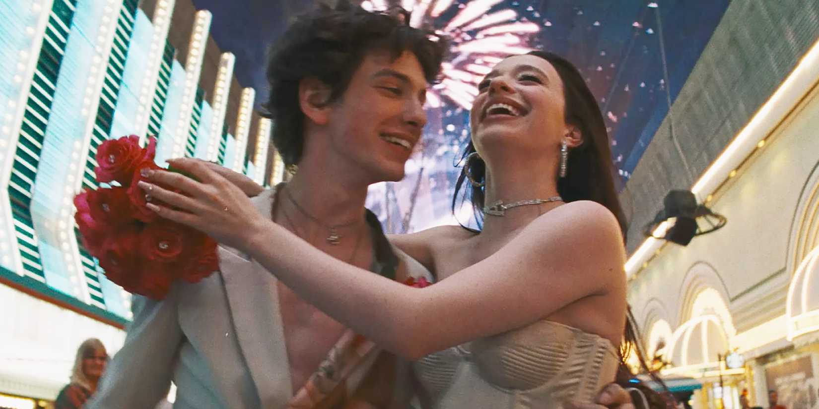 Ani and Ivan walking while embracing during an early romantic scene in Anora (2024)