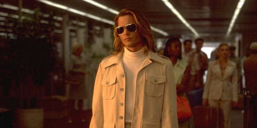 Johnny Depp with a crowd following him in Blow