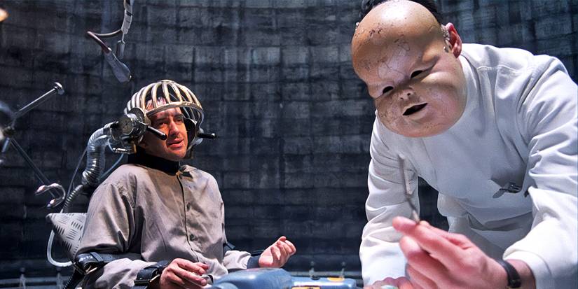 A man with a baby's face next to a man in a torture chair in Brazil