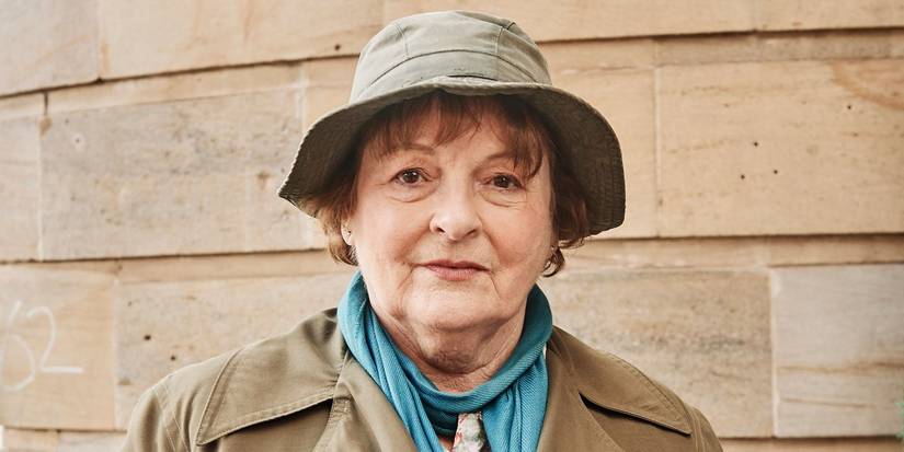 Brenda Blethyn posing as Vera Stanhope with a cap, slightly smiling