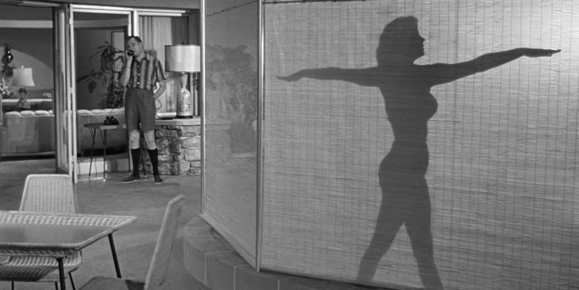 Rhonda Fleming poses for Vincent Price in Fritz Lang's While The City Sleeps (1956)