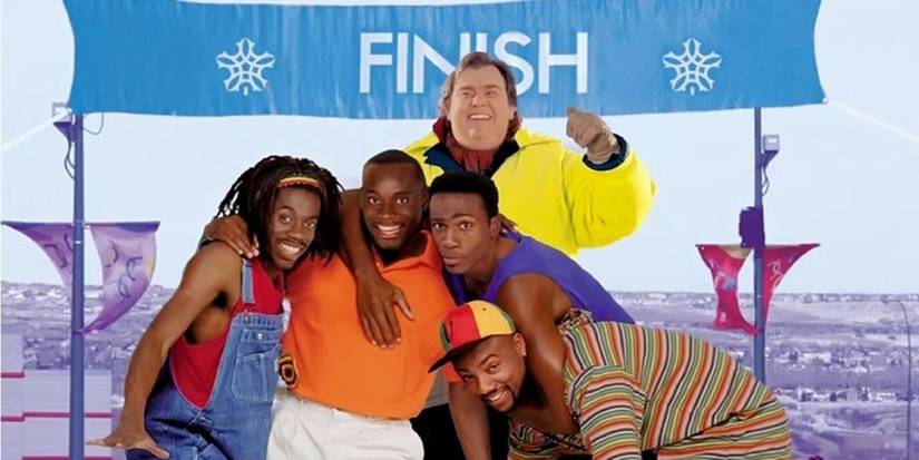 John Candy, Doug E. Doug, and the cast stand in front of a finish line in Cool Runnings.