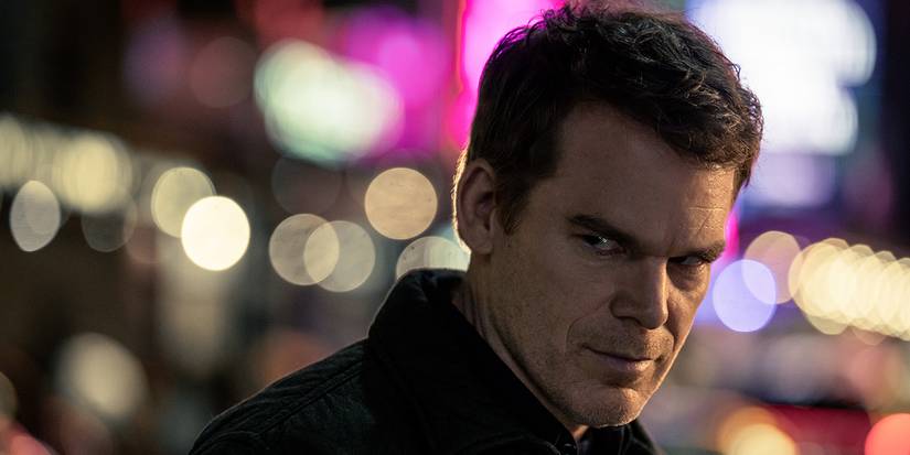 Dexter Morgan glaring at someone on the streets of a lit-up New York in Dexter: Resurrection