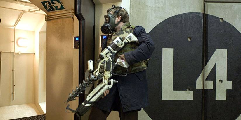 Man in a gas mask holding a futuristic weapon