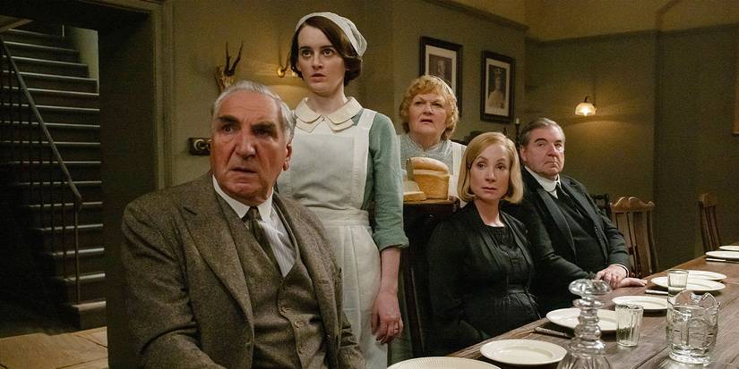The cast of Downton Abbey: The Grand Finale  seated at the servants' dinner table