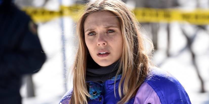 Elizabeth Olsen stands in the snow by a crime scene in Wind River