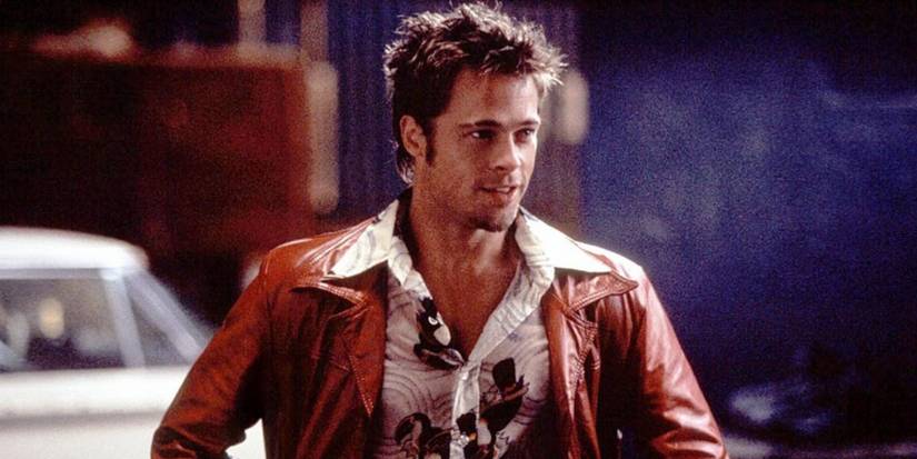 Brad Pitt in a leather jacket looking ahead in Fight Club.